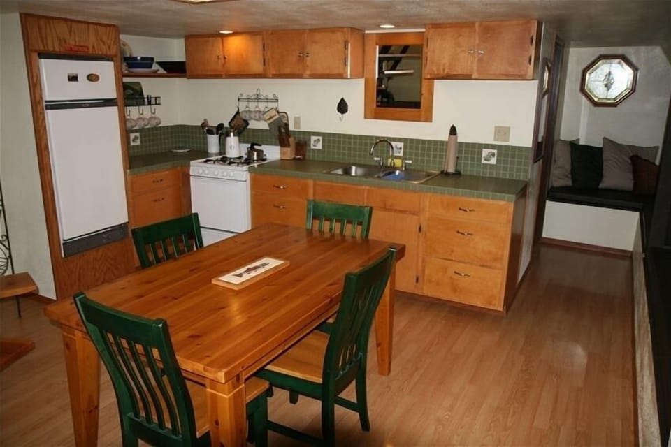 The fully supplied kitchen. A long padded bench at right sleeps 2-3 people.