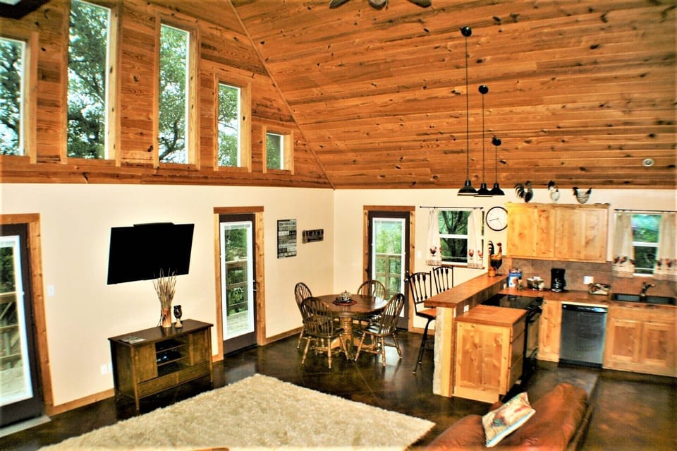 Open living room with high ceiling and hill country views