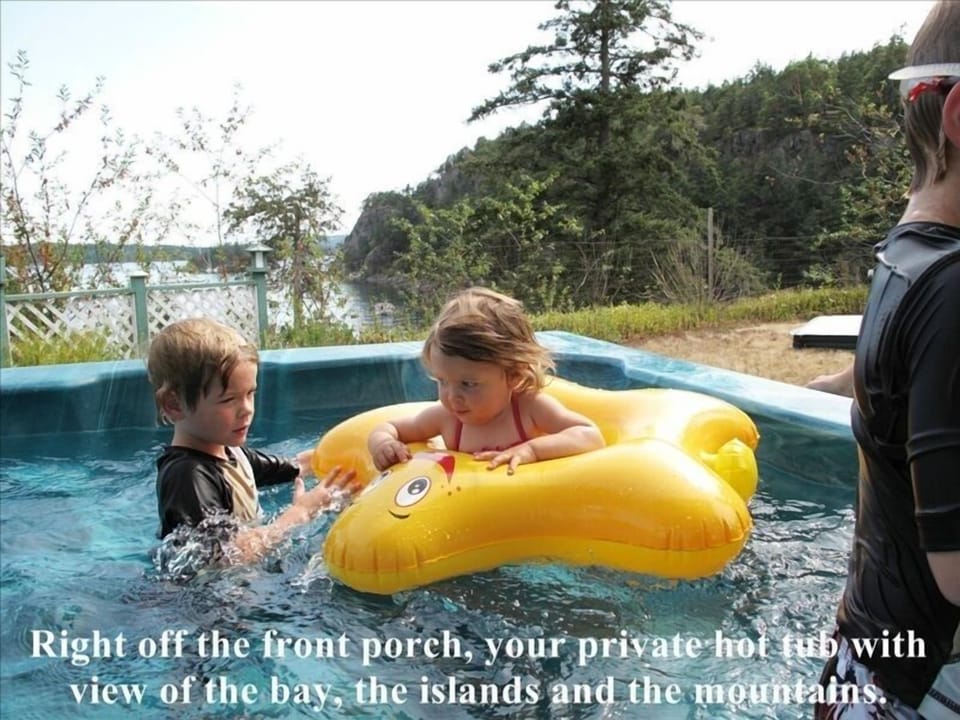 Right off front porch, private hot tub with view bay, islands, and mountains