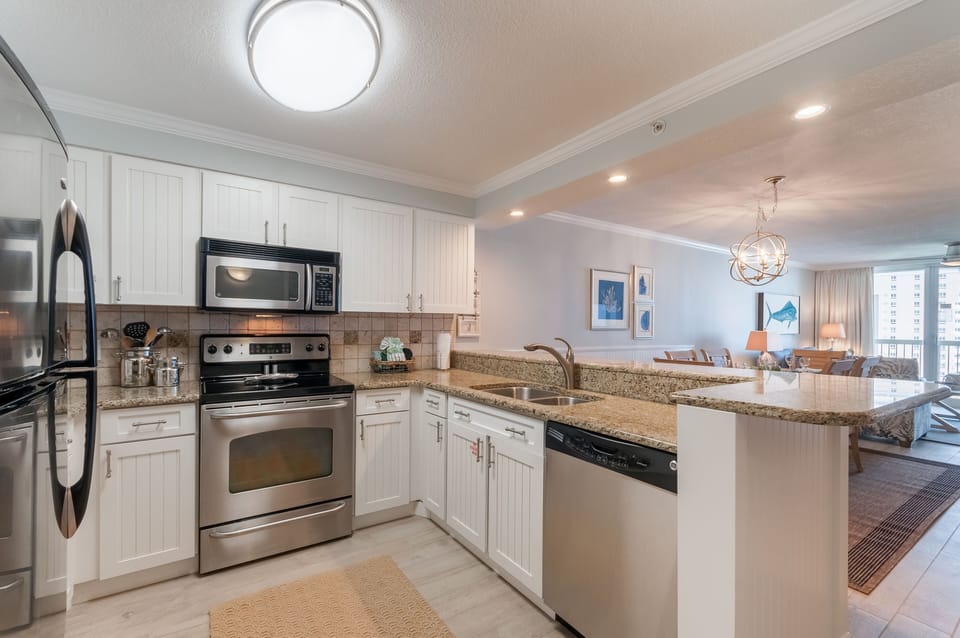 Kitchen features stainless appliances and granite counter tops. 
