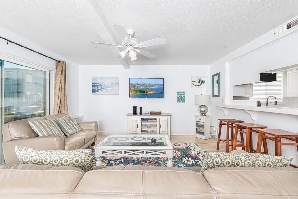 View of main living spaces from the front entry. Open floor plan between living, kitchen and dining areas
                