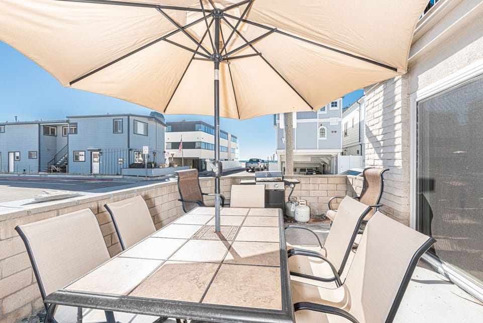 Enjoy the ocean breeze on the front patio just one house from the sand with ocean views
                