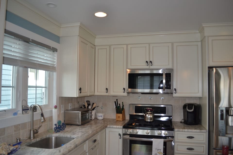 Kitchen with granite countertops, nautical motif, Keurig, + stainless appliances