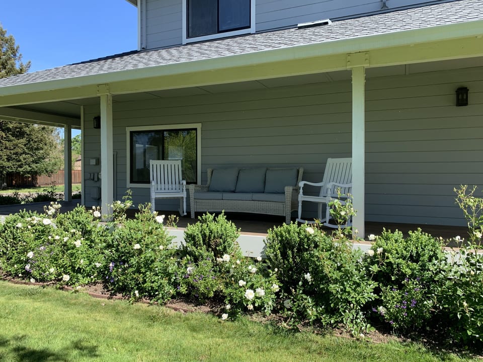 Couch and rocking chairs on the side porch provide a perfect place for R&R