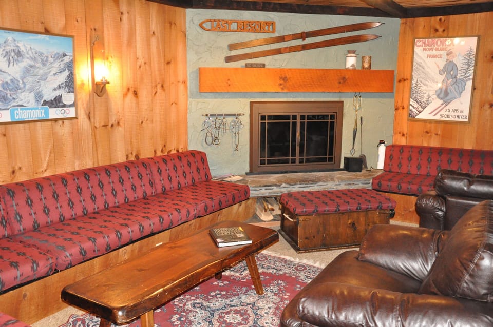Seating for 16 around Fireplace with posters from my skiing around the world.
