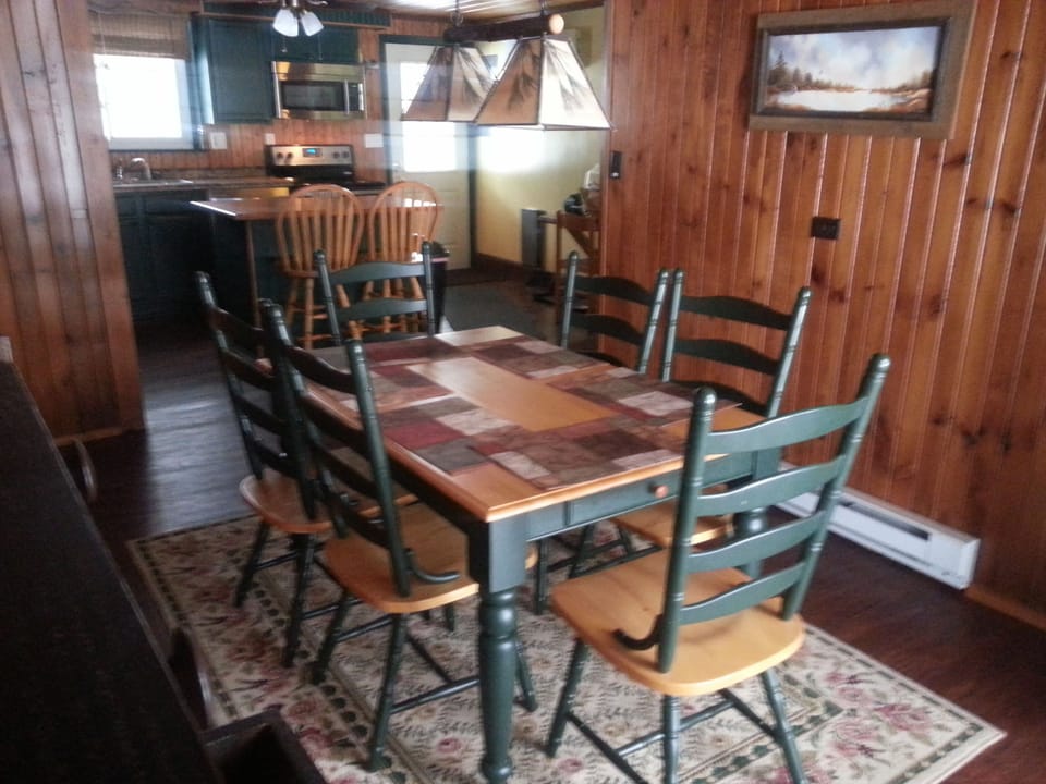 Dining area seats 6 at table and 2 at island counter
