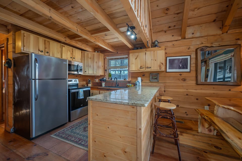 open kitchen area with large, handcrafted kitchen table