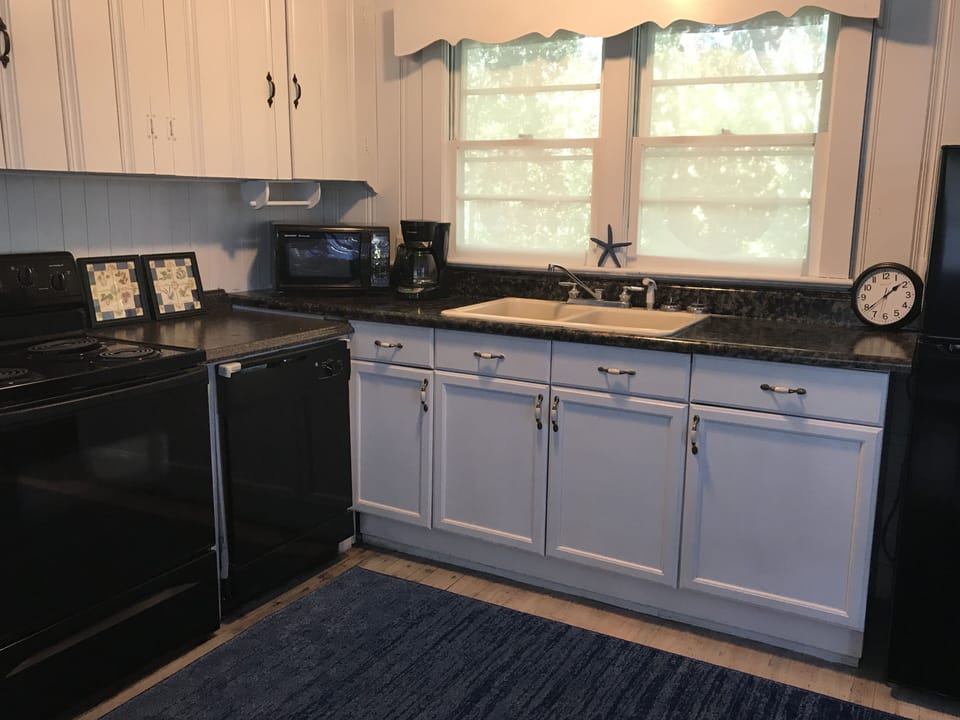 Cottage kitchen with all of the modern amenities! Lots of charm, open concept.