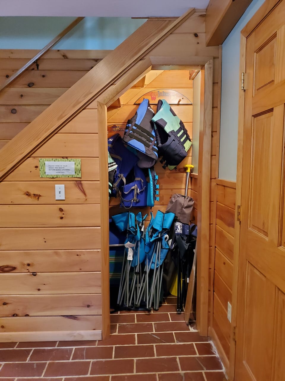 Life vest, boat cushions, canoe paddles, and canvas chairs