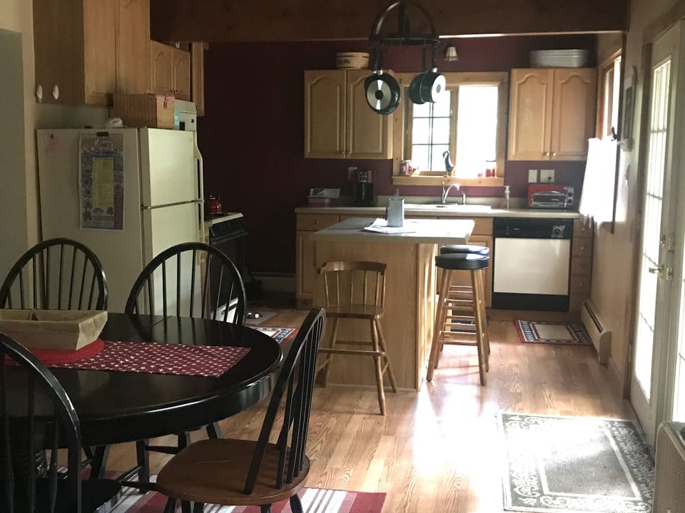 Large open kitchen with French doors leading outside to deck.