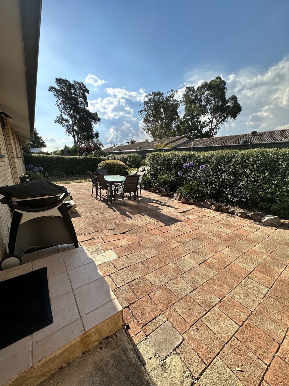 Rear courtyard with outdoor dining and BBQ