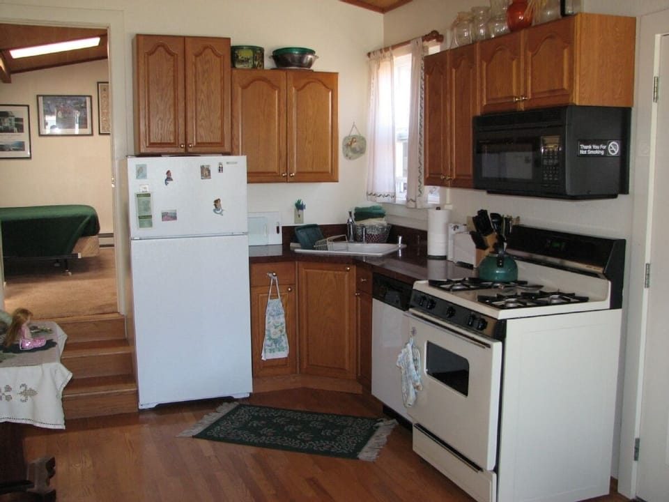 Full Kitchen with Microwave, Dishwasher
Stocked with dishes, silverware.        
