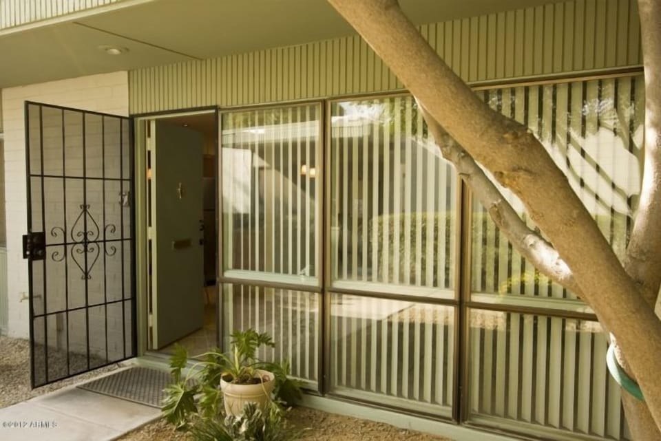 Front of condo; no plant and a small patio is in place.

