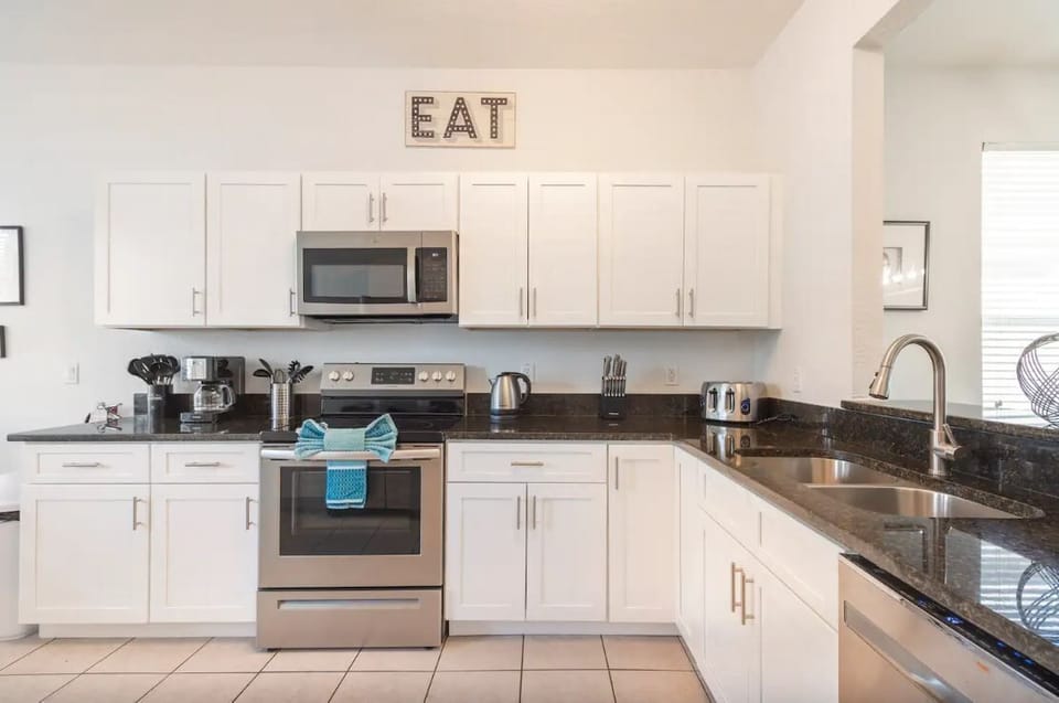 Stylish new kitchen with granite counters, stainless steel appliances