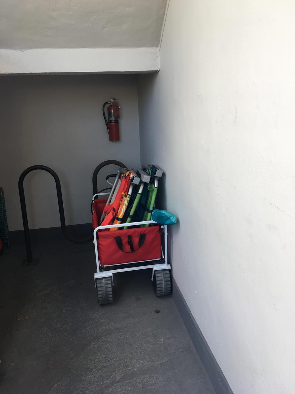 beach cart with chairs and umbrellas