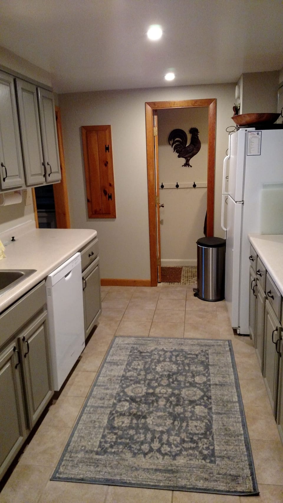 View of kitchen with newly installed dishwasher, entry to full bath seen