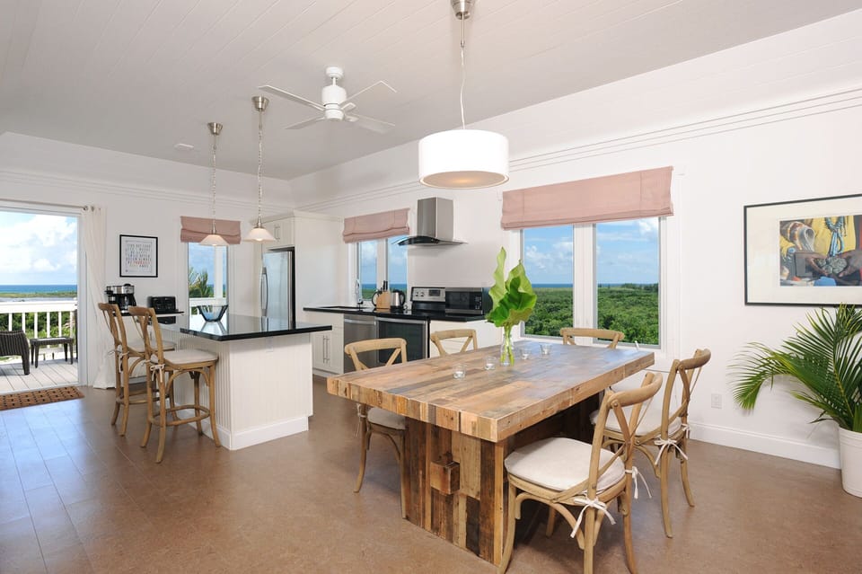 Modern kitchen in black granite and stainless steel, with views of both oceans.