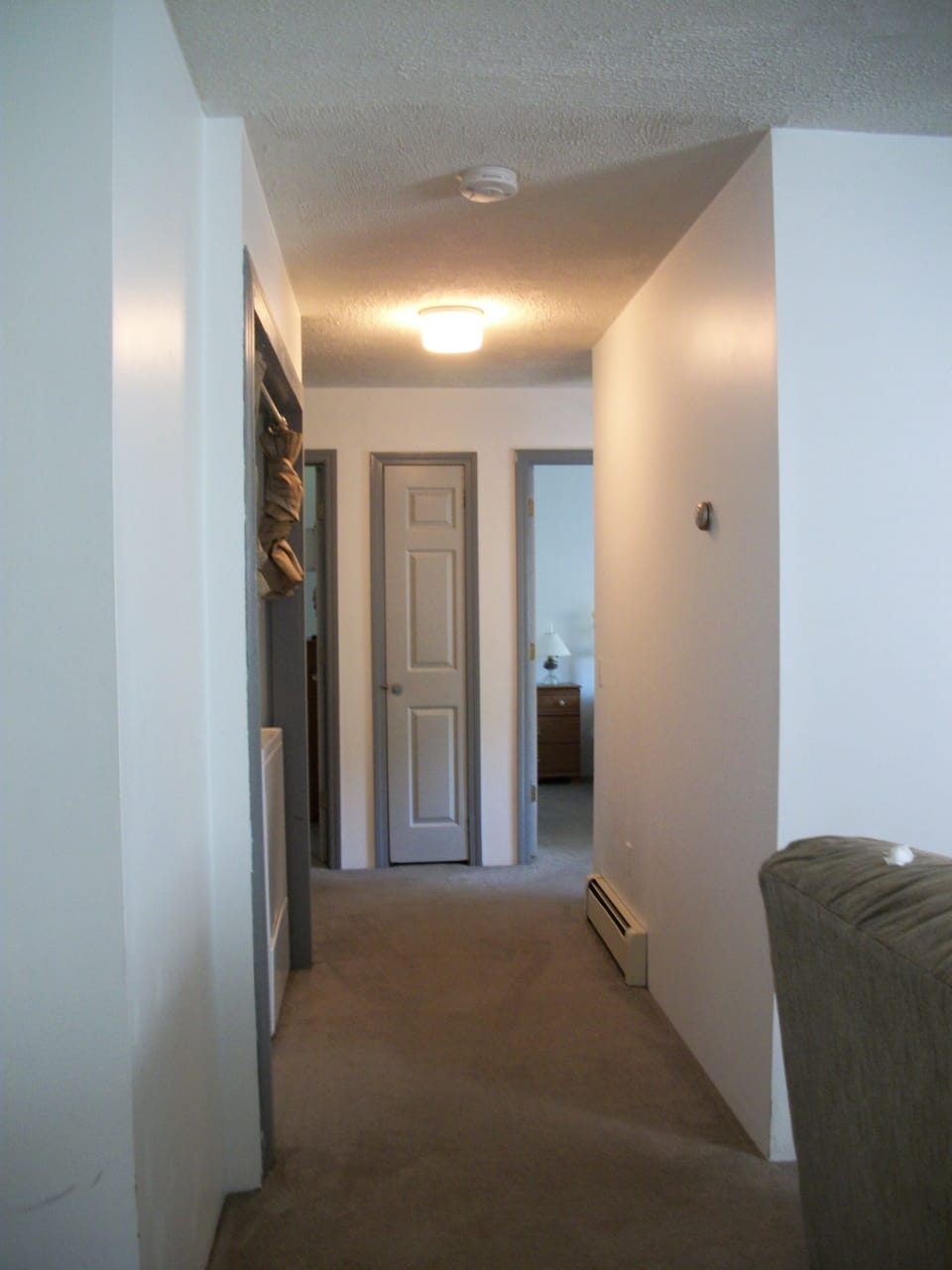 hallway, washer/dryer, full bathroom 1 bedroom to left, 2 bedrooms to right.