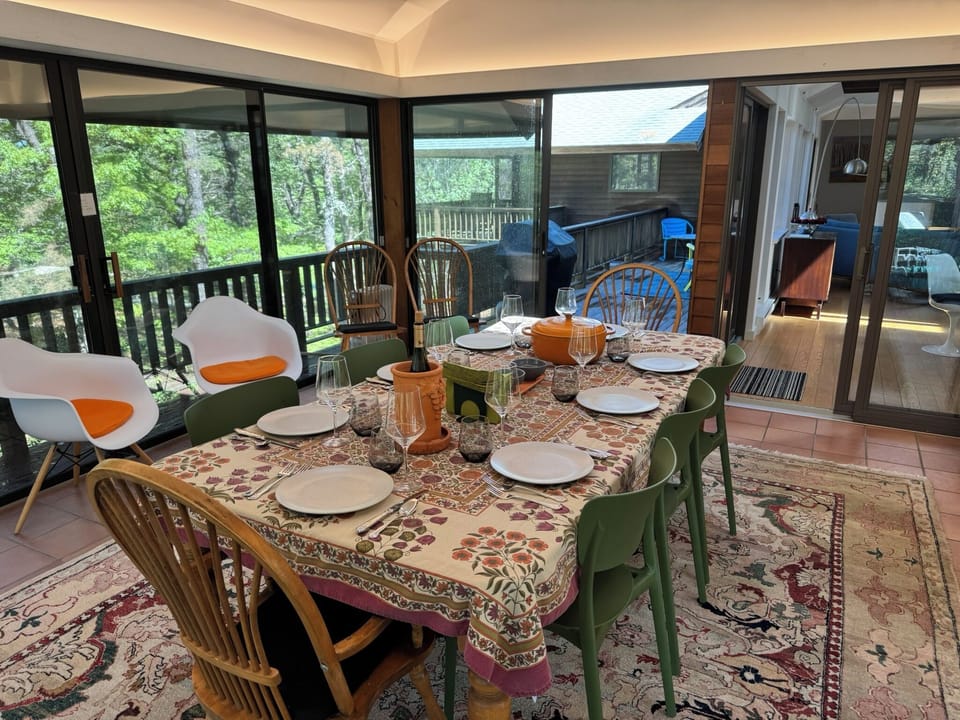 The all glass screened-in dining room is like eating in a treehouse.
