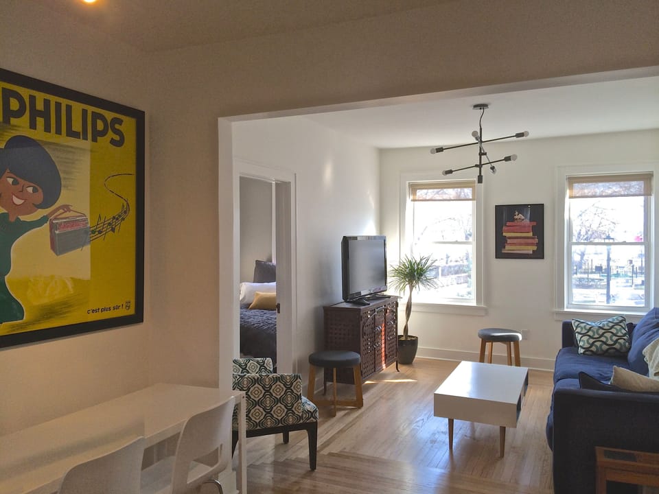Living room with windows overlooking park.