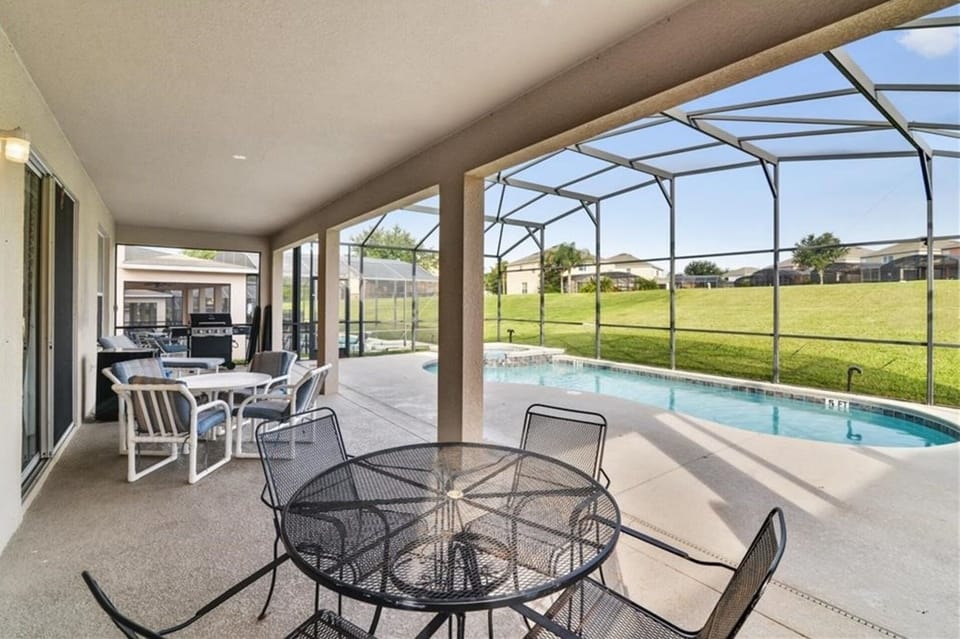 Huge lanai  with  two patio tables and BBQ Grill
