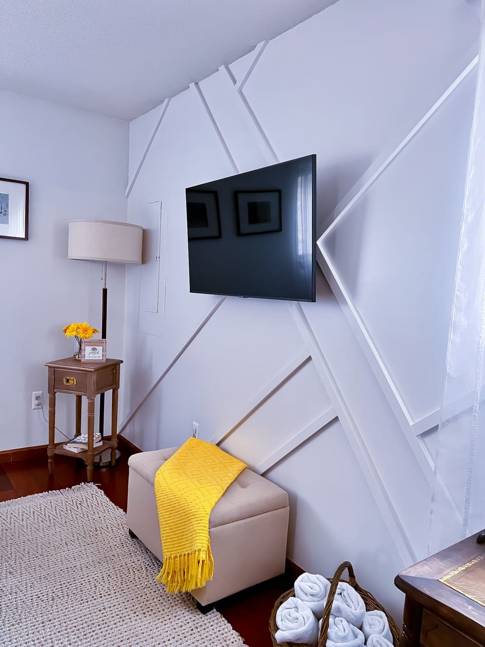 A stylishly decorated accent wall complemented by a 55-inch HDTV.