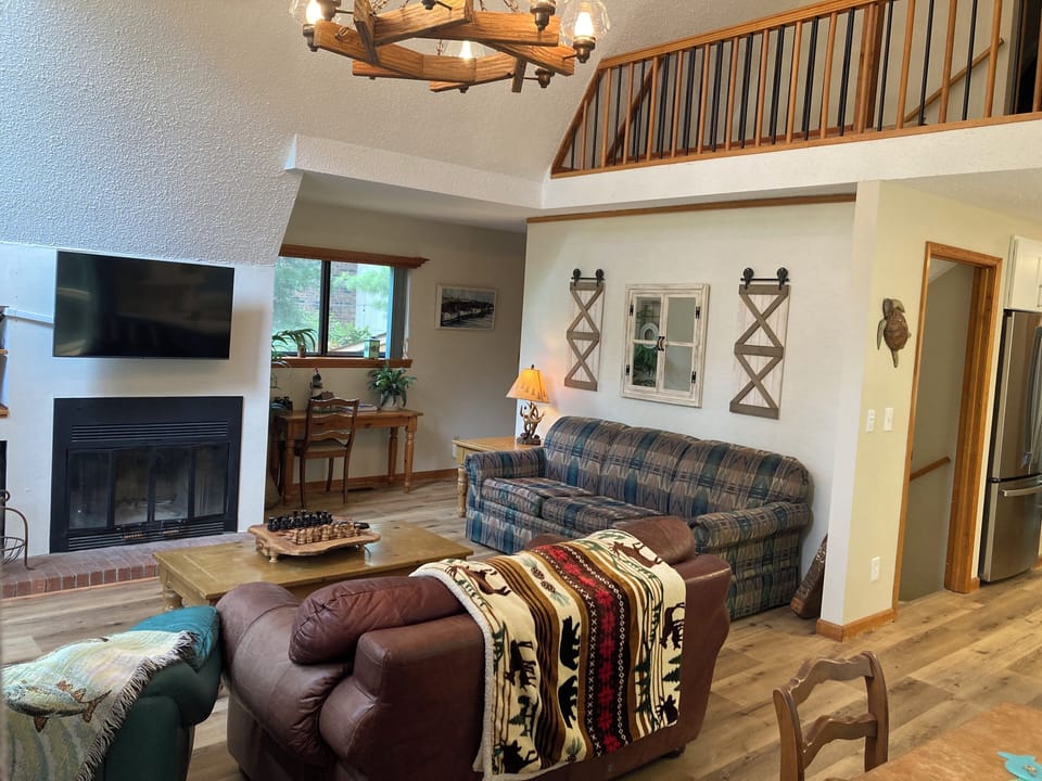 Great Room with TV over Fireplace and Balcony to Twin Bed Room