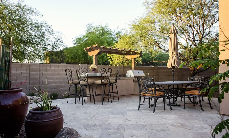 The backyard is your own private oasis with an outdoor BBQ and dining area