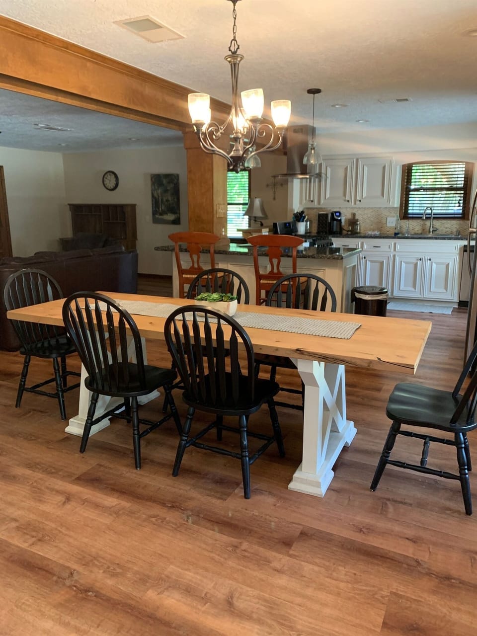 Closeup of dining area with kitchen in the background. Owners can provide more chairs if needed.
