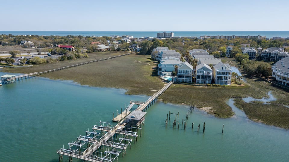 Waters Edge community from the river side looking east towards the Atlantic Ocean.  Fishing, crabbing and sunset watching are all favorites from this deep water dock.