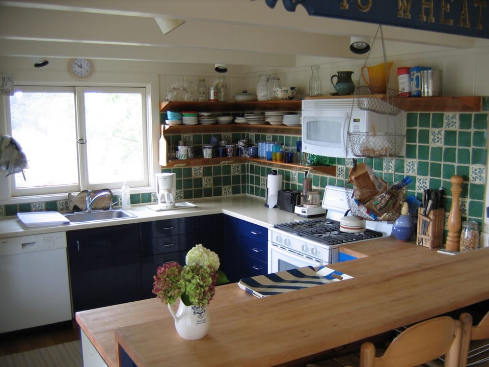 Chef-Equipped Kitchen with butcher block breakfast peninsula and stools