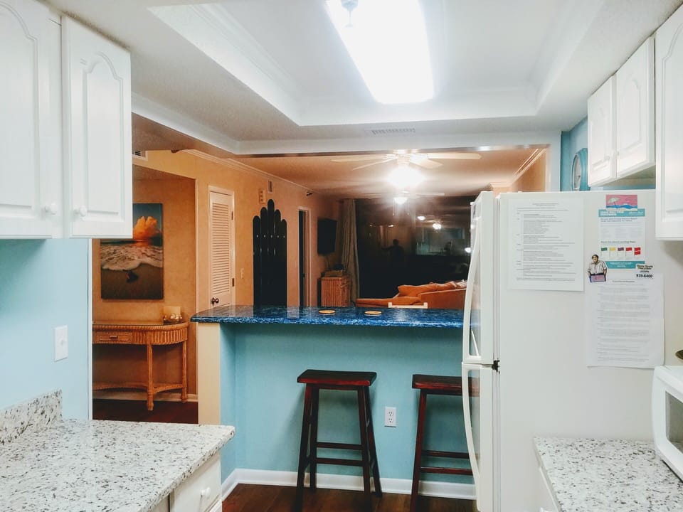 Standing in kitchen looking out into dining room/living room