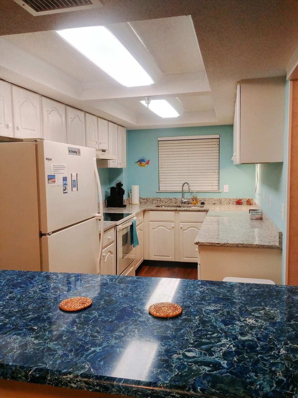 View into galley kitchen with NEW granite/quartz countertops
