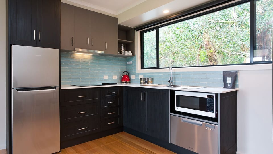 Modern kitchen with dishwasher and good sized fridge. (No oven.)