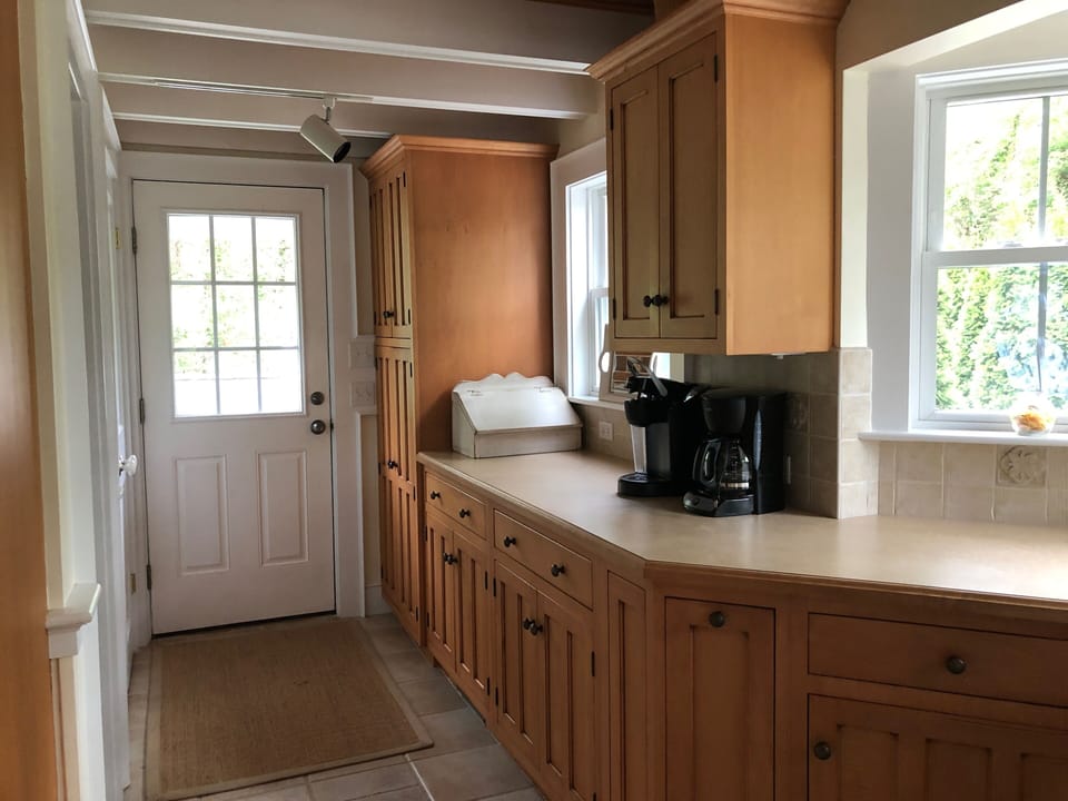 Plenty of space in this kitchen. Back door leads to back yard with BBQ grill.