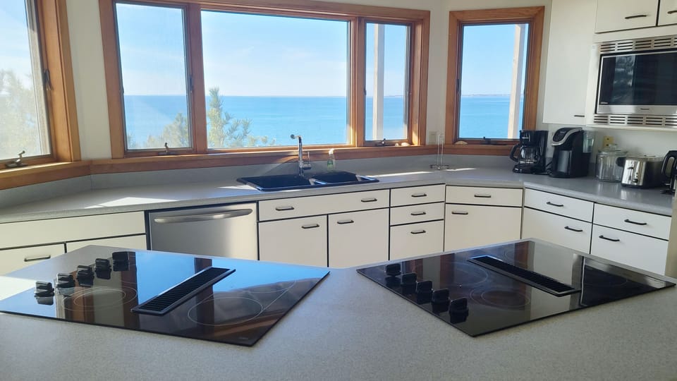 Kitchen has two cooktops and a wall oven