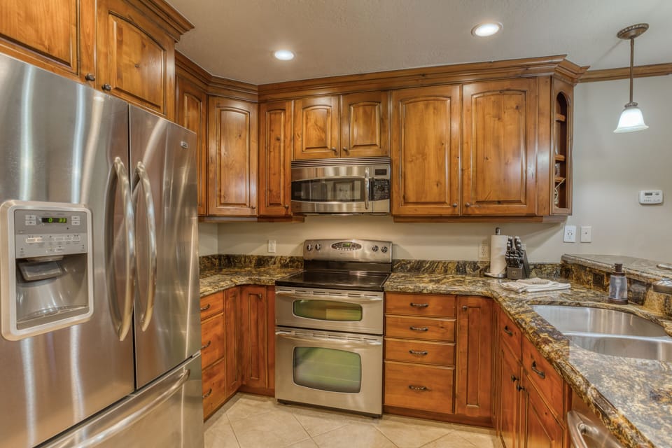 Granite, all stainless appliances & knotty alder cabinets in the kitchen. 