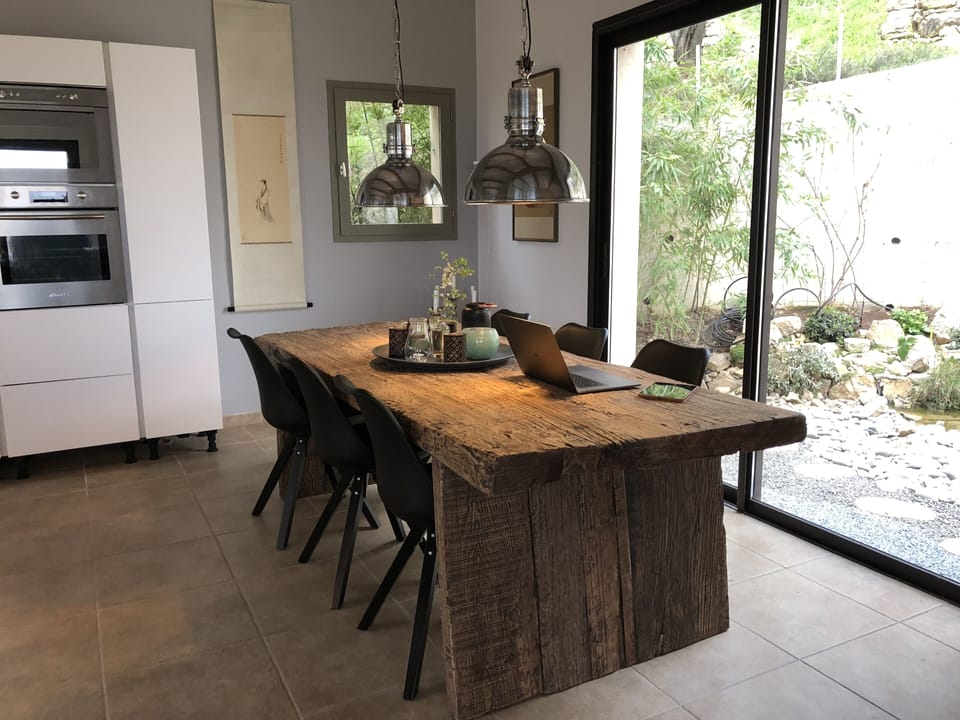 old wooden dining table with view to the japanese garden