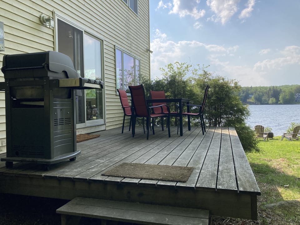 Slider off the family room to the porch with lake views and Weber gas grill.