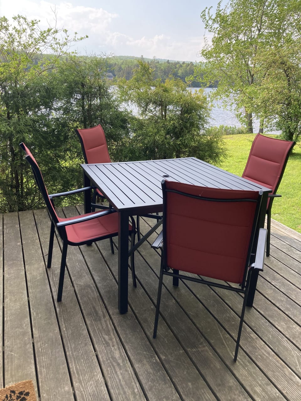 Outdoor dining for four; with a second small serving table in the yard