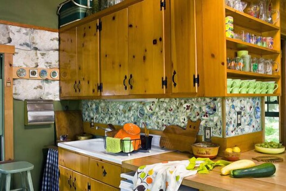 counter and sink with broken dish mosaic backsplash