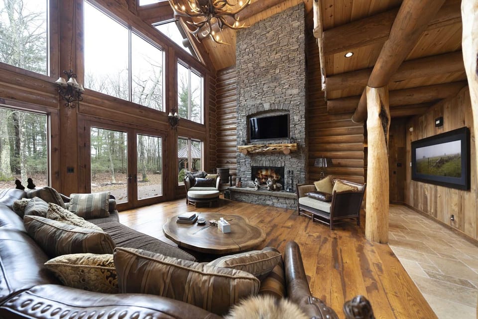 Glass front living room with floor to ceiling stone fireplace 