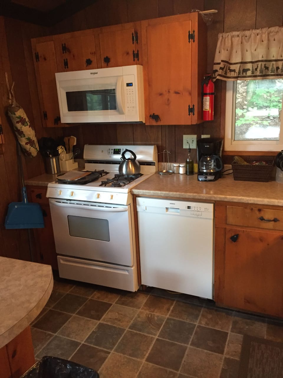 Kitchen range, microwave, and dishwasher.