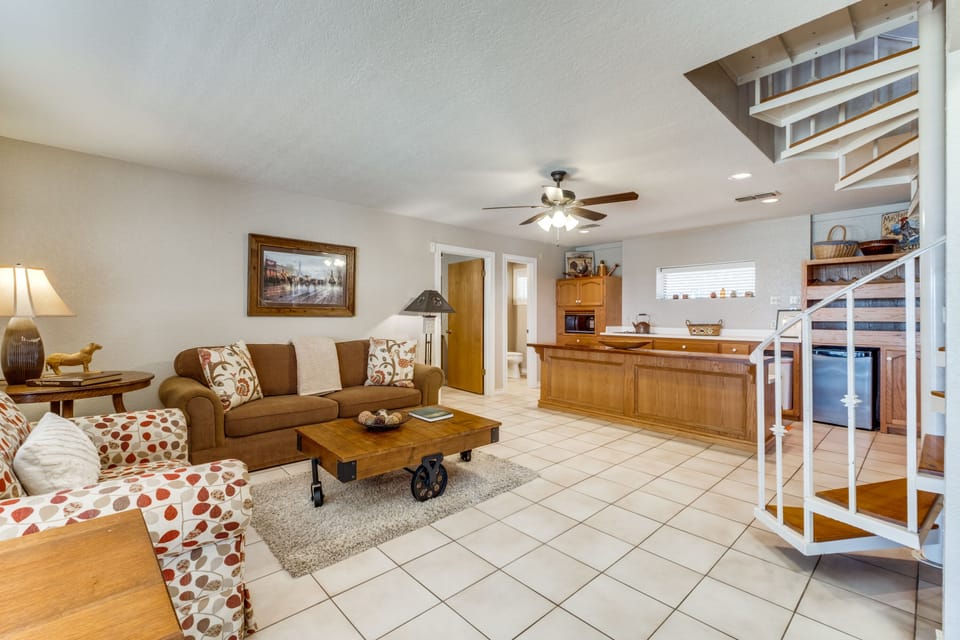 Downstairs living area with queen sleeper sofa, 1/2 bath, utility and smart TV.