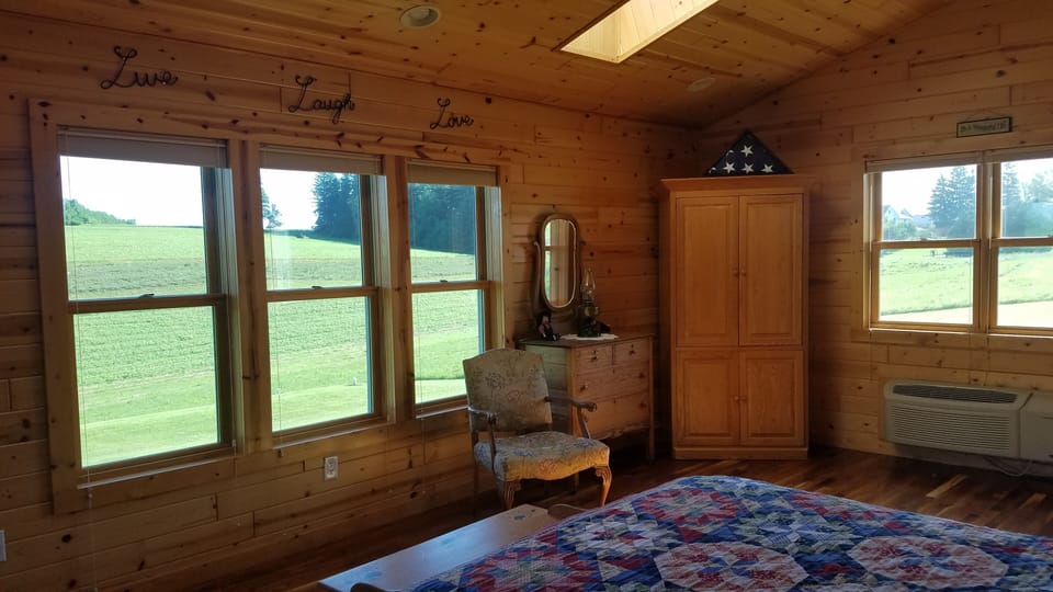 Bedroom with views of farm field 