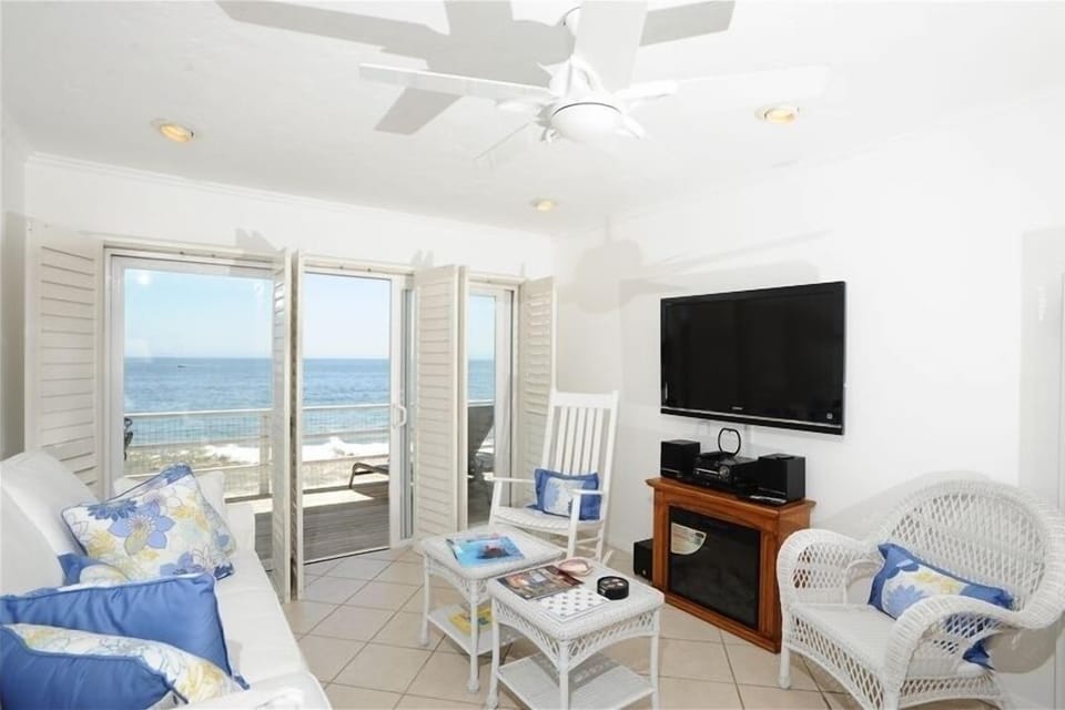 Living room includes flat screen TV & fireplace