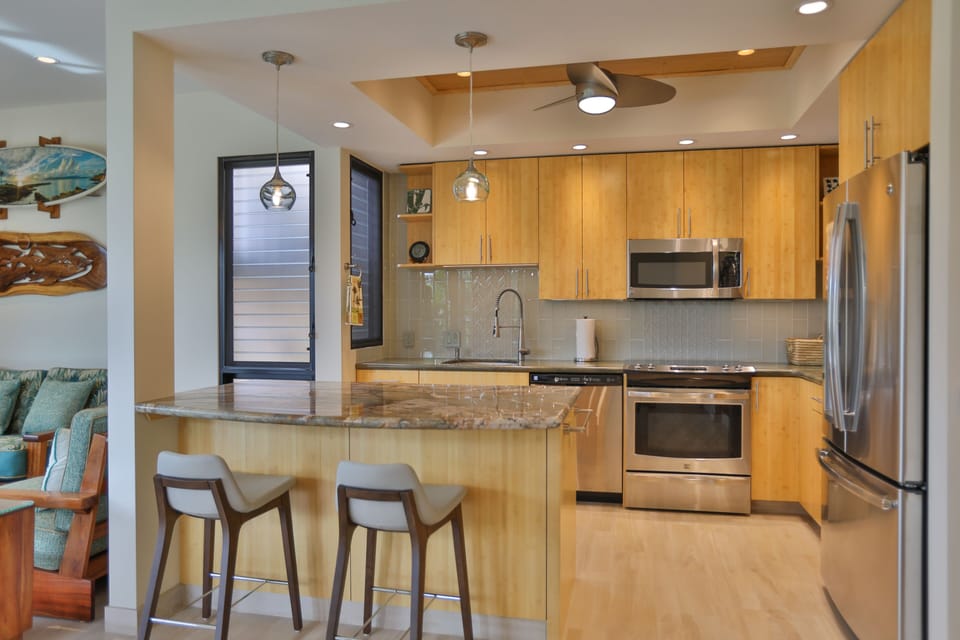 Open concept kitchen with granite counter tops and bamboo cabinets