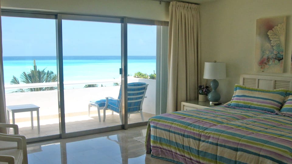 Master bedroom with private bathroom and beachfront balcony