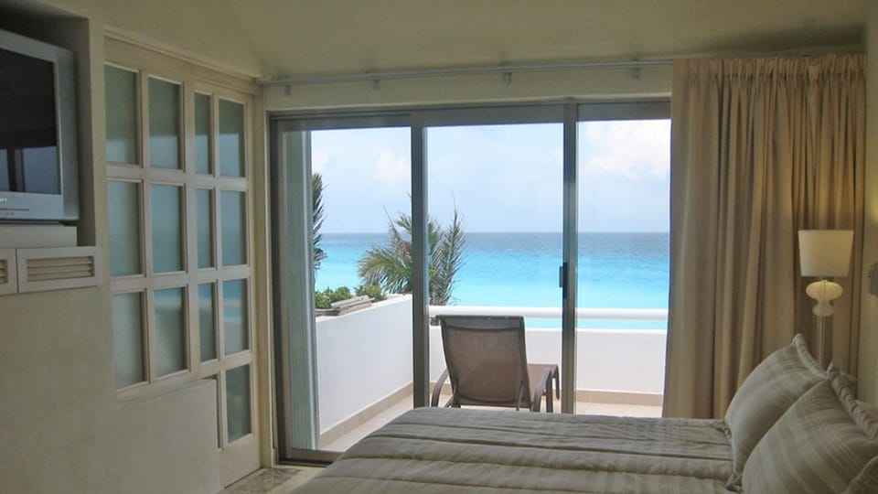 Upstairs private bedroom and bathroom with large oceanfront sunbathing patio.