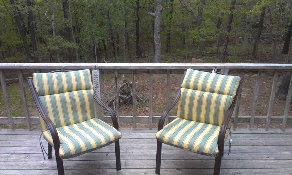 Deck with propane grill overlooks large fenced in yard